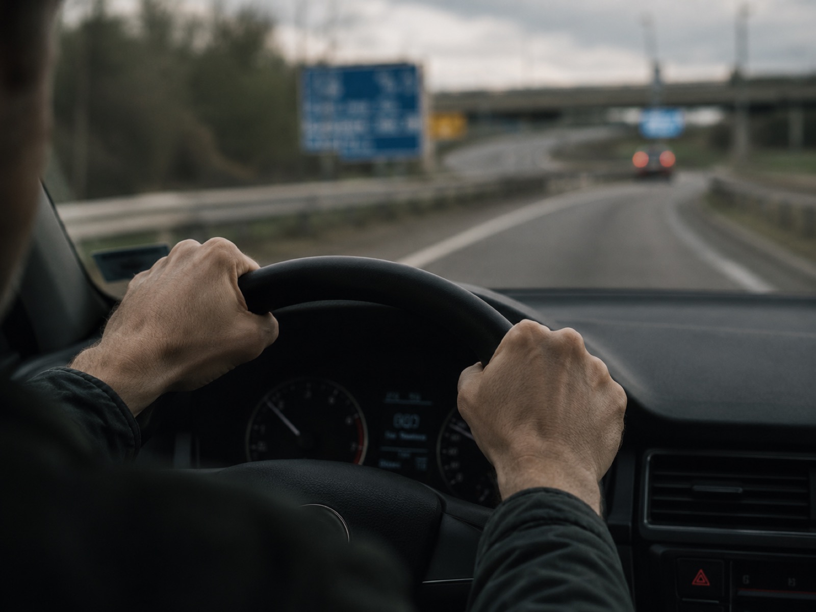 A driver gripping the wheel, feeling anxious as they approach a busy motorway.
